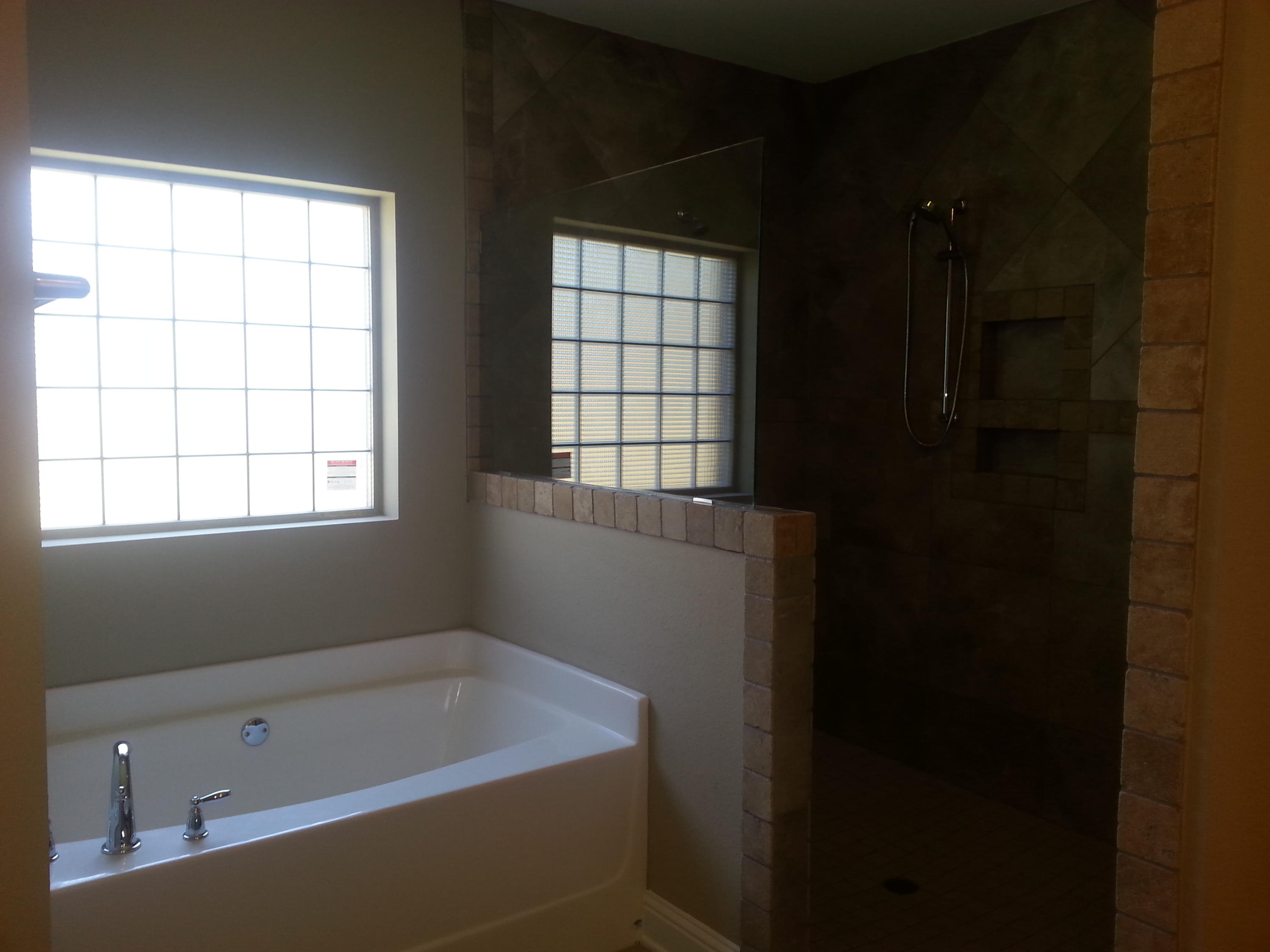 2442 Cove Road Navarre, FL 32566 - Photo 18 of 23 a bathroom with a bathtub and window