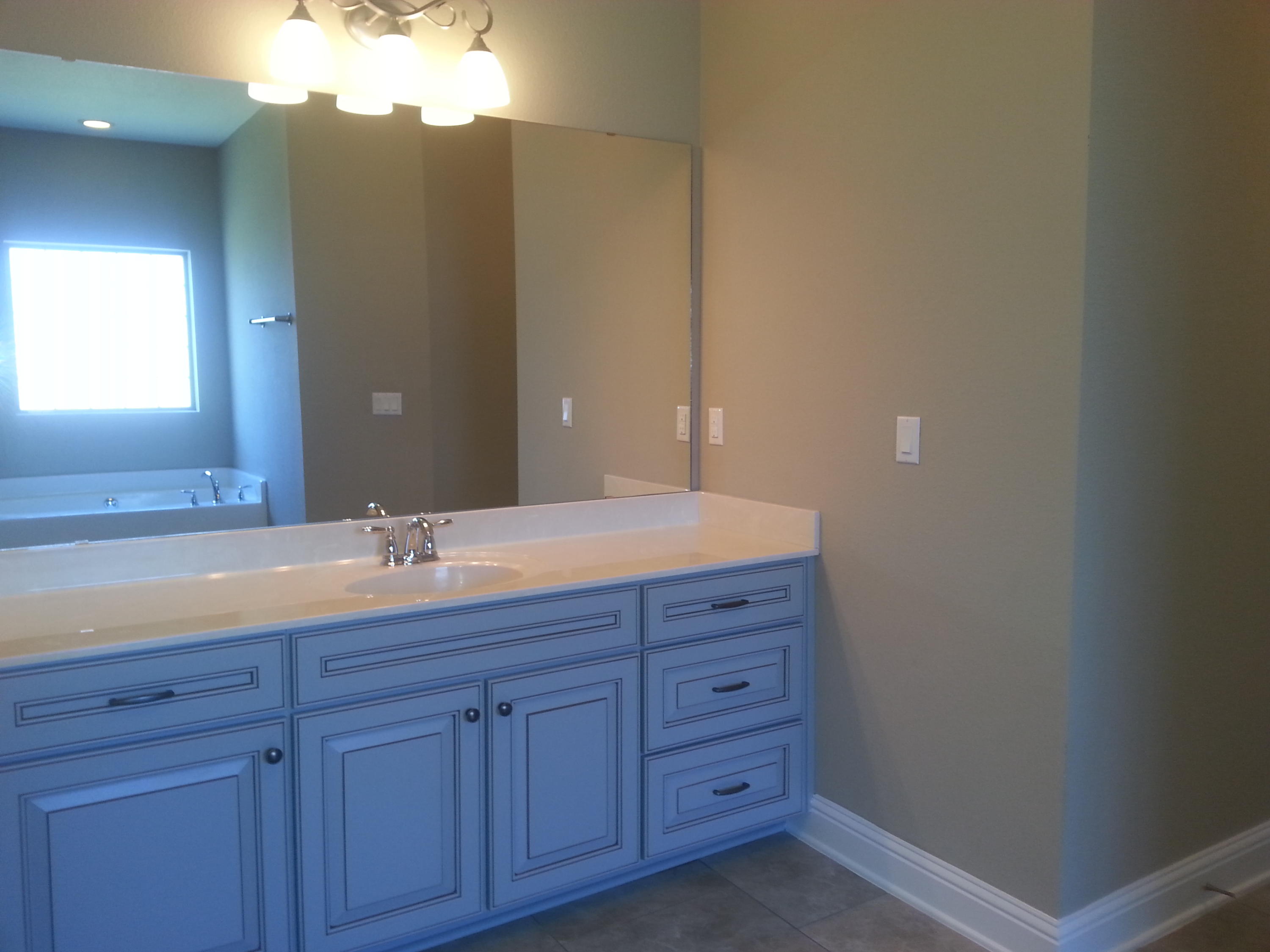 2442 Cove Road Navarre, FL 32566 - Photo 19 of 23 a bathroom with a granite countertop sink and a mirror