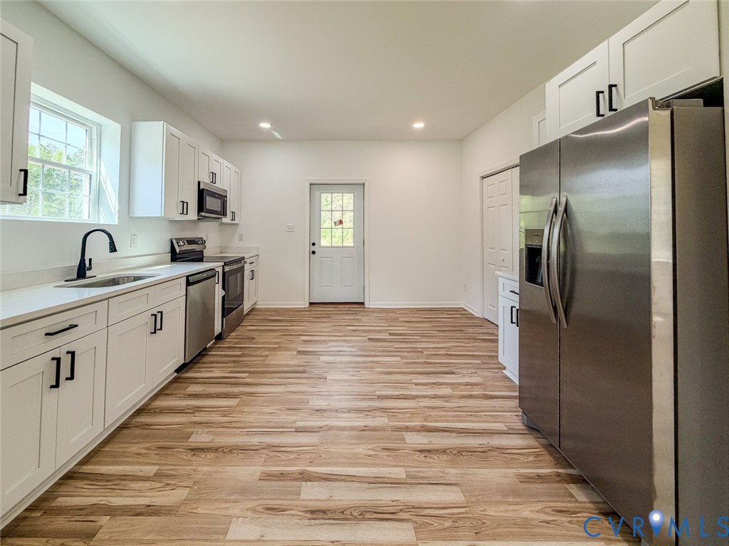 19614 Manson Church Road McKenney, VA 23872 - Photo 4 of 24 a kitchen with granite countertop a refrigerator and cabinets