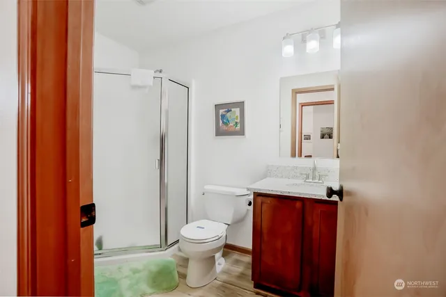a bathroom with a toilet a sink and mirror