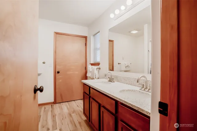 a bathroom with a sink a mirror and a shower