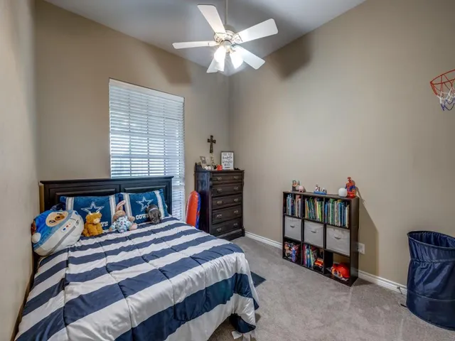 a bedroom with a bed a baby crib and a window
