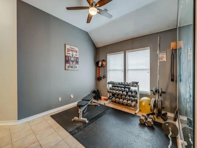 a room with gym equipment and a window