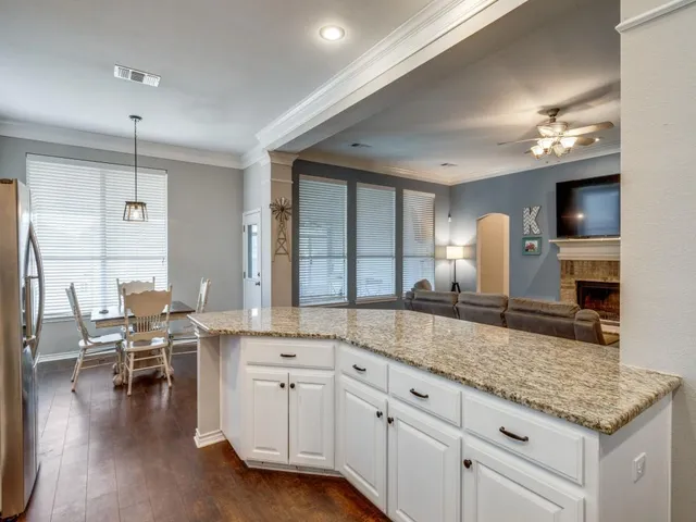 a kitchen with center island table and chairs