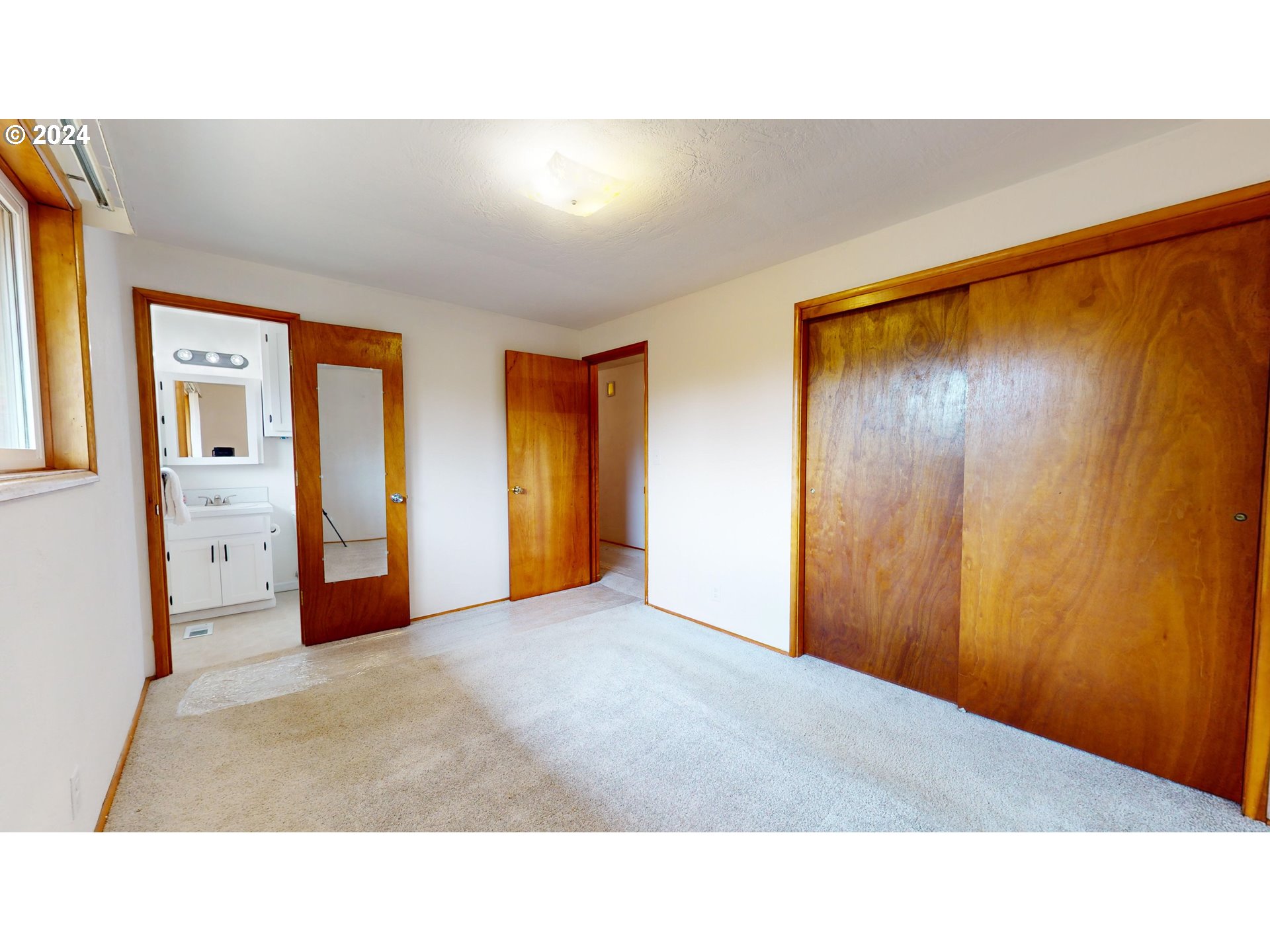 4675 Daisy Street Springfield, OR 97478 - Photo 22 of 43 a open living room with a couch and wooden door