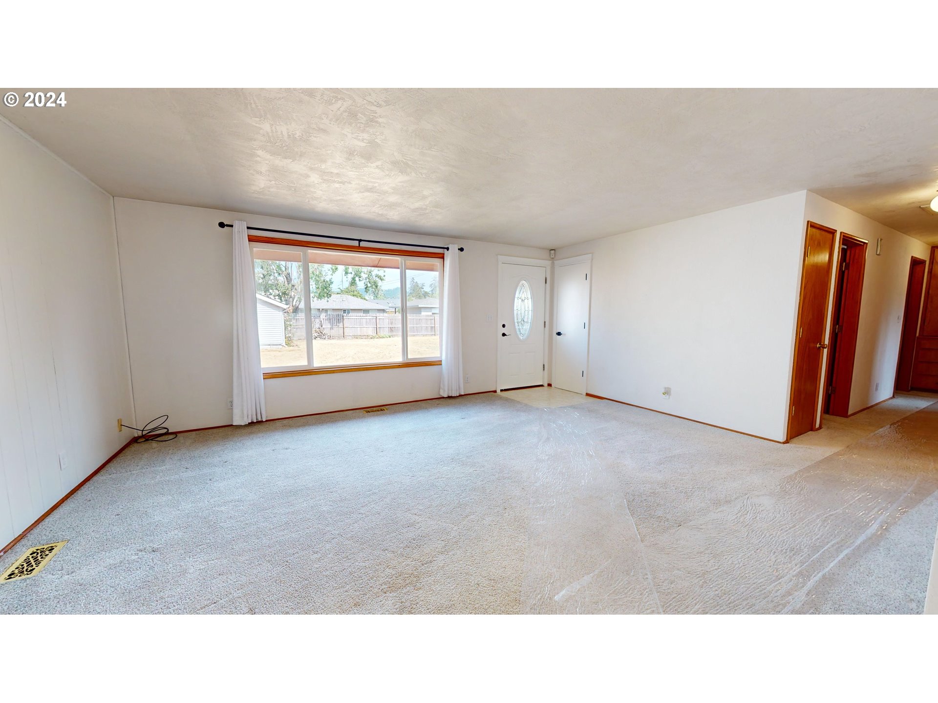 4675 Daisy Street Springfield, OR 97478 - Photo 4 of 43 a open hall with a floor to ceiling window and a projector room