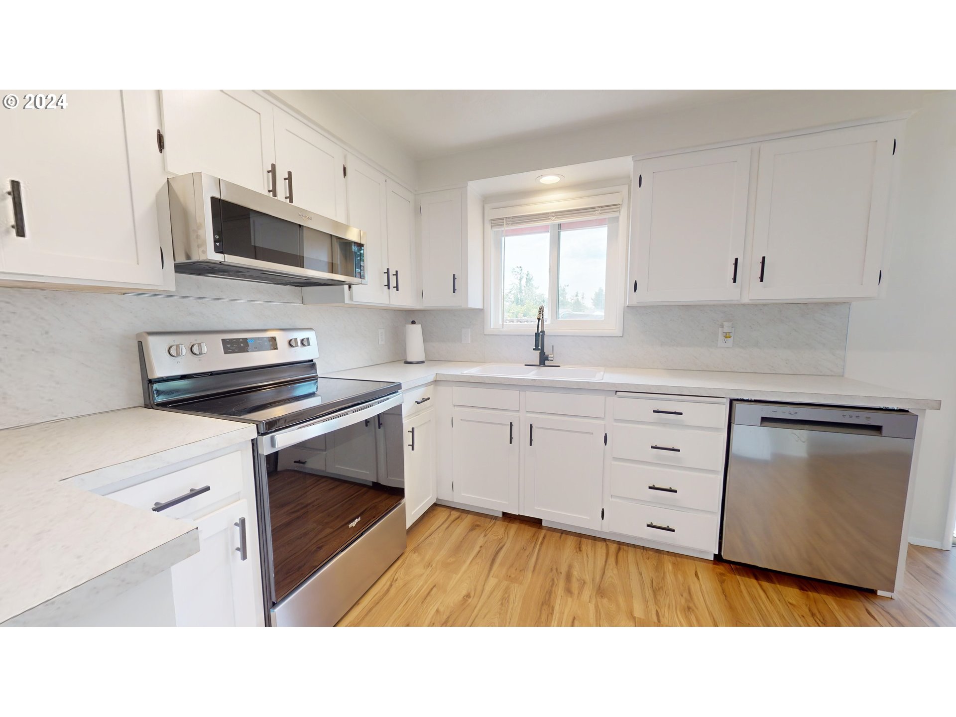4675 Daisy Street Springfield, OR 97478 - Photo 8 of 43 a kitchen with stainless steel appliances a sink stove and cabinets