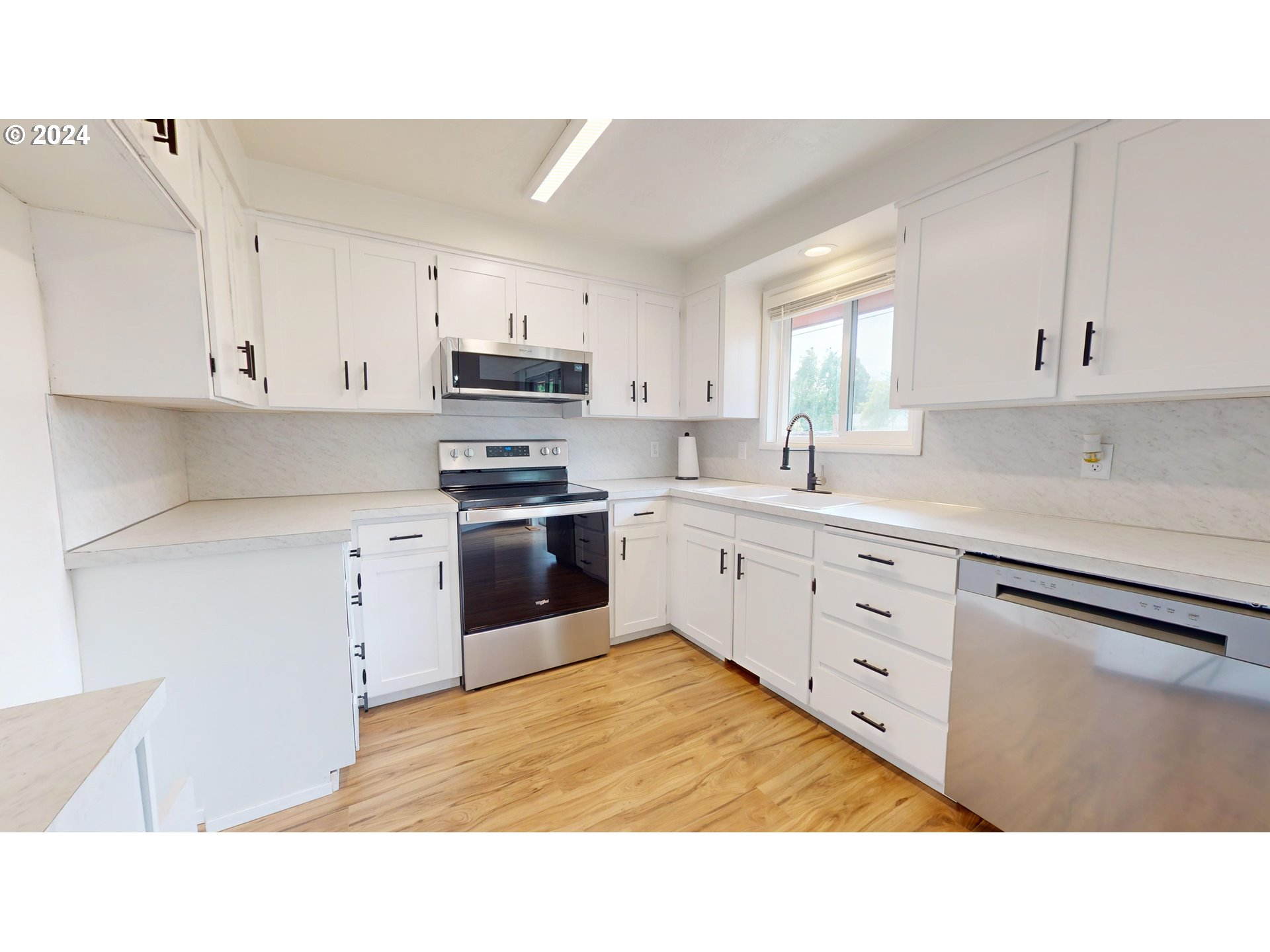 4675 Daisy Street Springfield, OR 97478 - Photo 9 of 43 a kitchen with white cabinets and white appliances