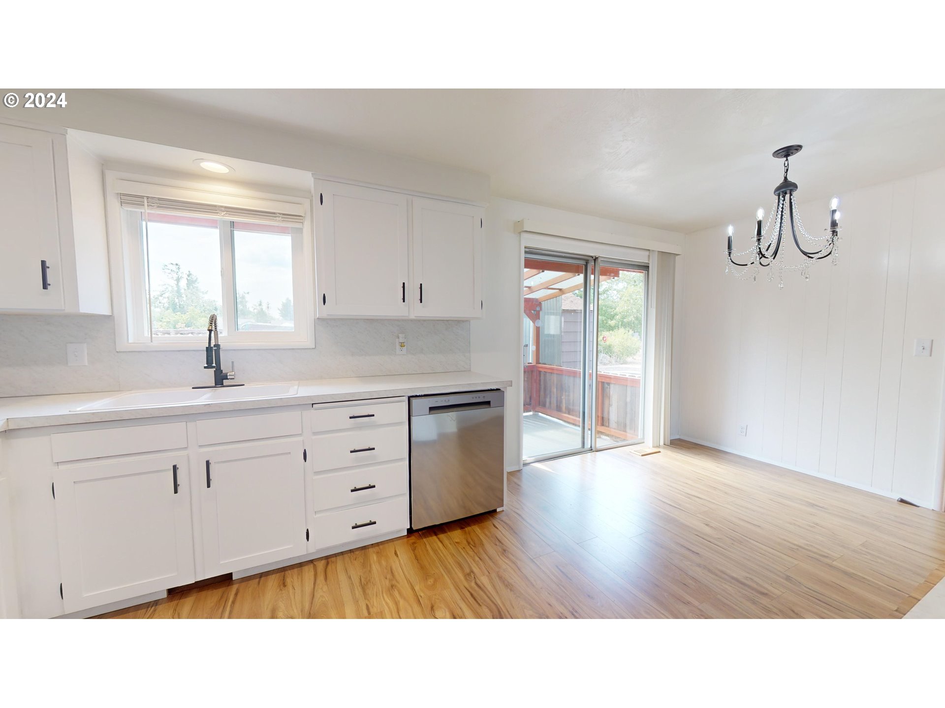 4675 Daisy Street Springfield, OR 97478 - Photo 10 of 43 a open kitchen with sink and dishwasher with wooden floor