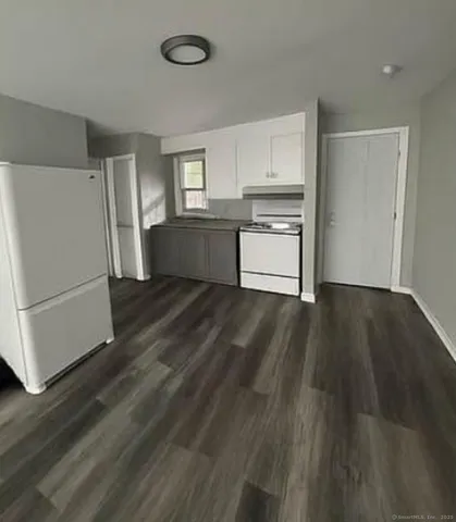 a kitchen with a refrigerator and a stove top oven