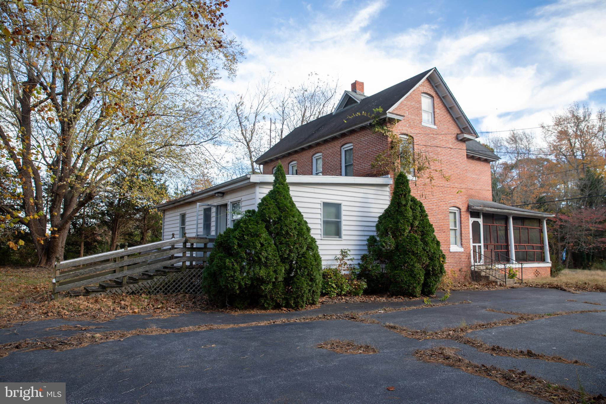 26121 Lewes Georgetown Highway Georgetown, DE 19947 - Photo 12 of 72 a front view of a house with a yard and garage