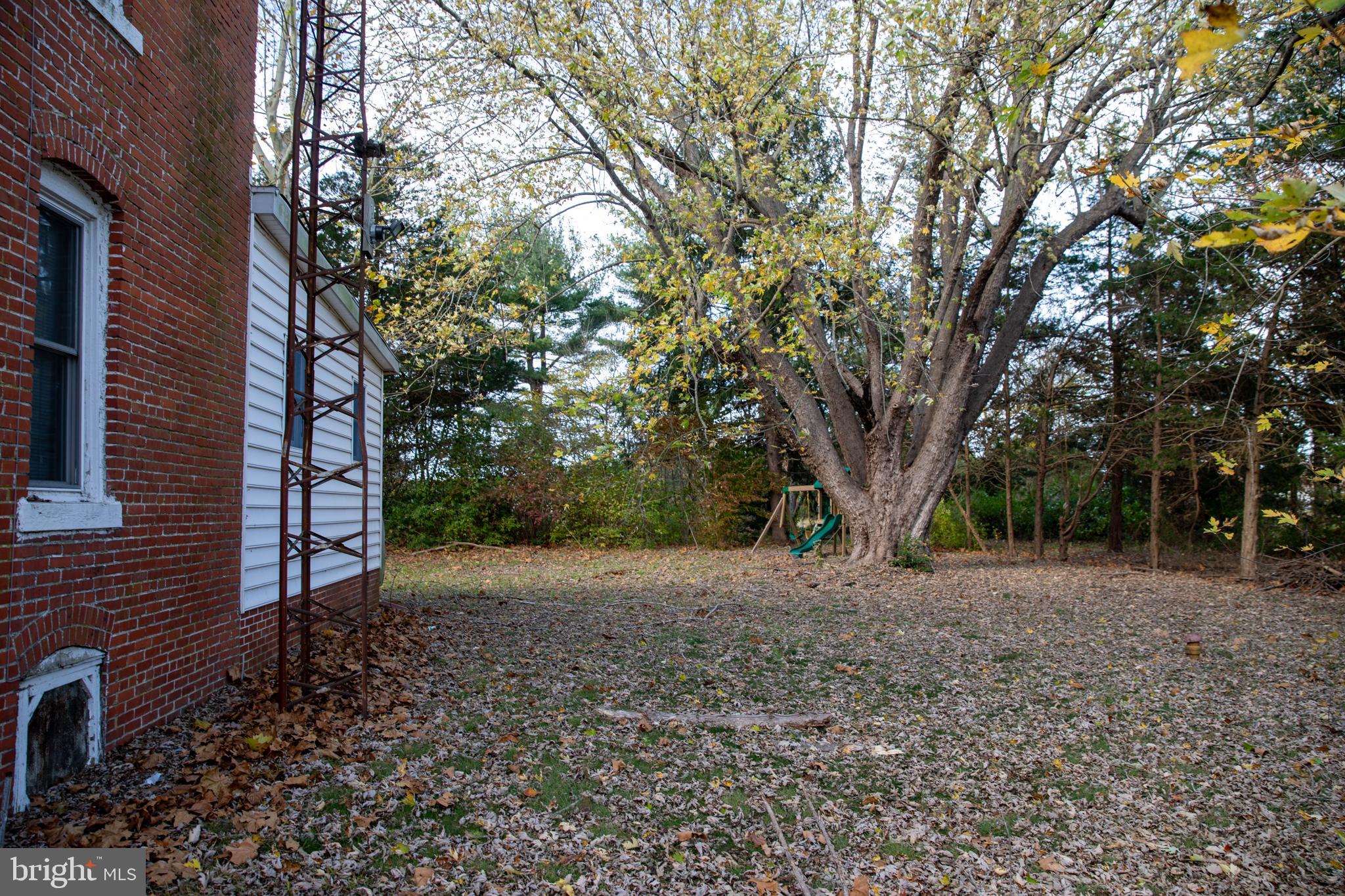 26121 Lewes Georgetown Highway Georgetown, DE 19947 - Photo 17 of 72 a backyard of a house with lots of green space