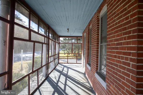 an empty room with wooden floor and a window