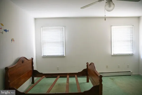 a wooden bench sitting in a room next to a window