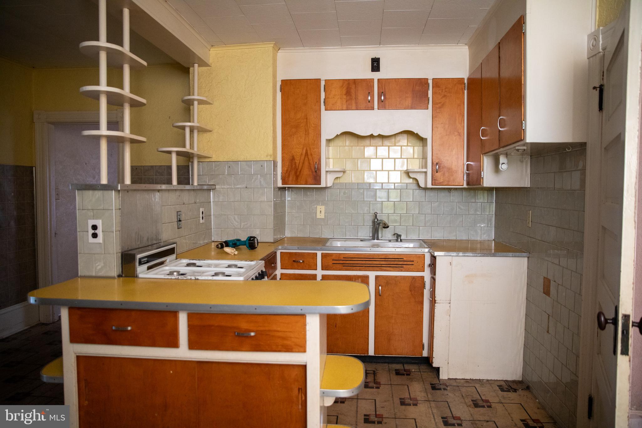 26121 Lewes Georgetown Highway Georgetown, DE 19947 - Photo 34 of 72 a kitchen with a stove a sink and a microwave