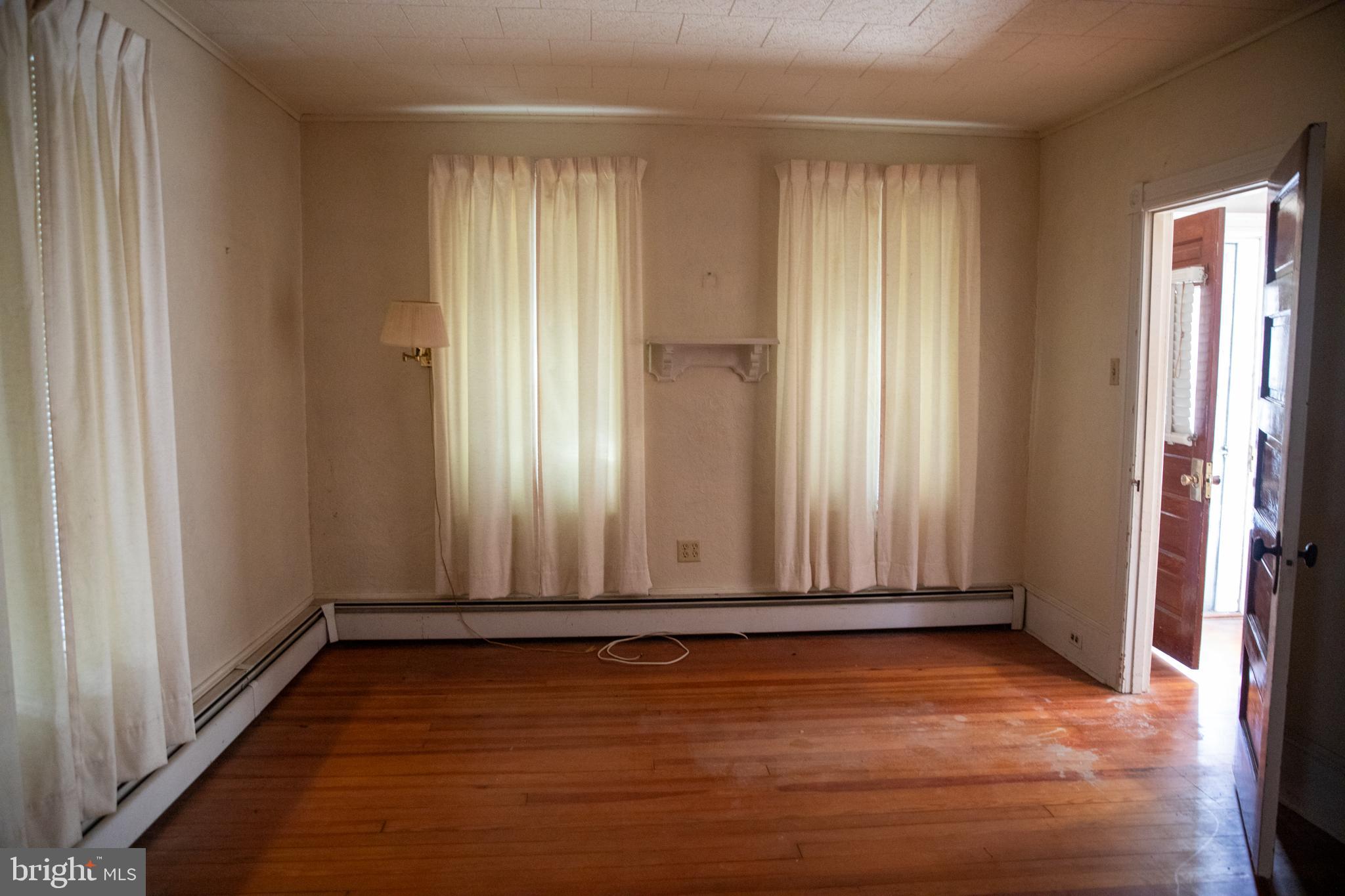 26121 Lewes Georgetown Highway Georgetown, DE 19947 - Photo 37 of 72 an empty room with wooden floor and a window