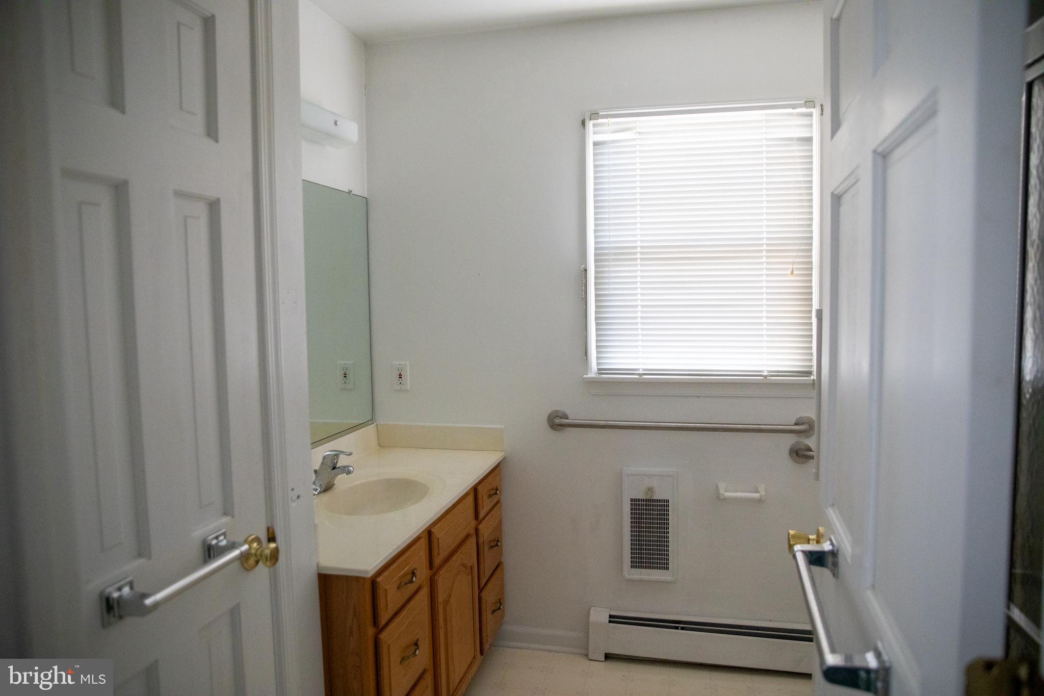 26121 Lewes Georgetown Highway Georgetown, DE 19947 - Photo 42 of 72 a bathroom with a sink and a window