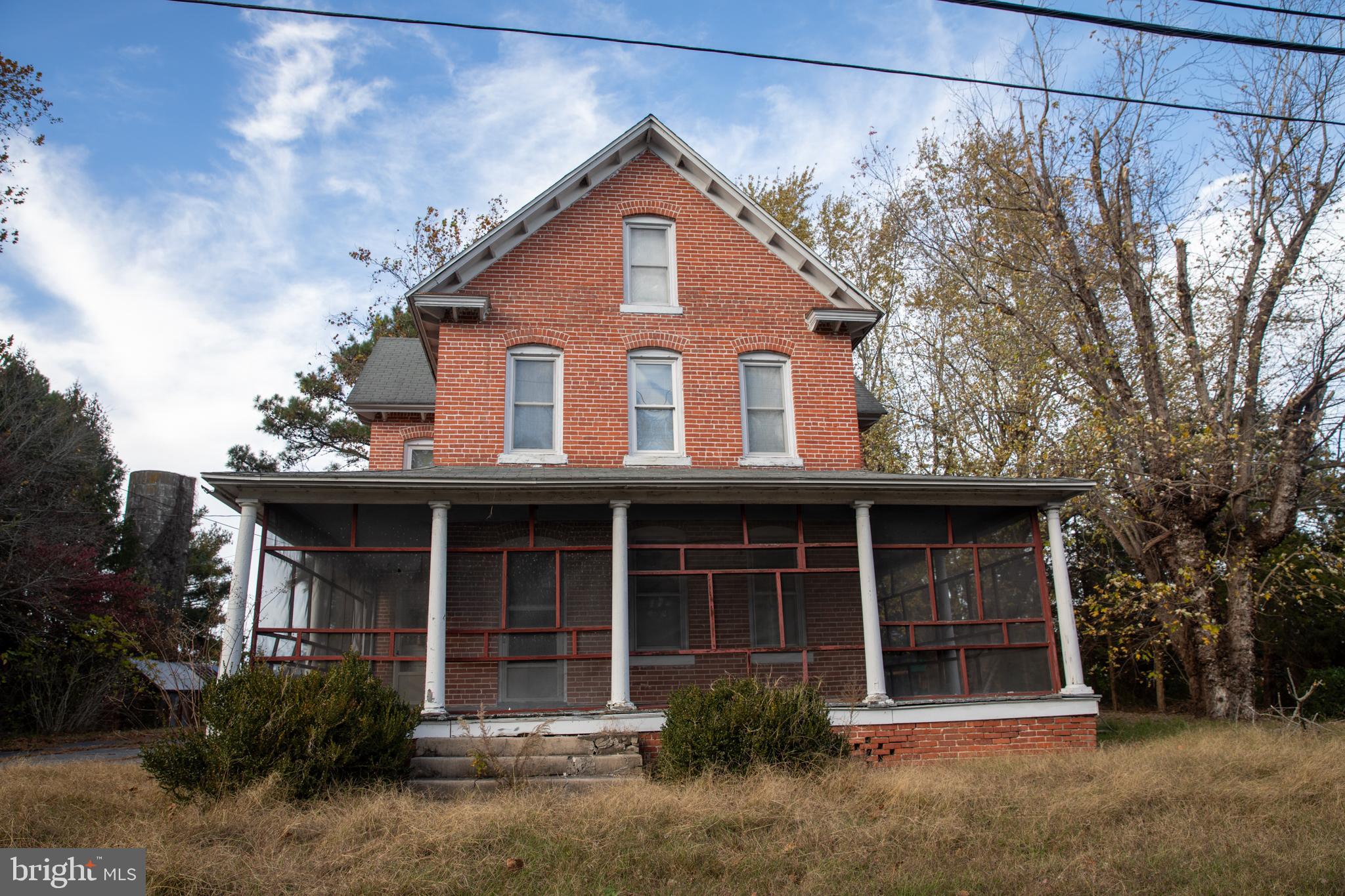 26121 Lewes Georgetown Highway Georgetown, DE 19947 - Photo 5 of 72 a front view of a house with a garden