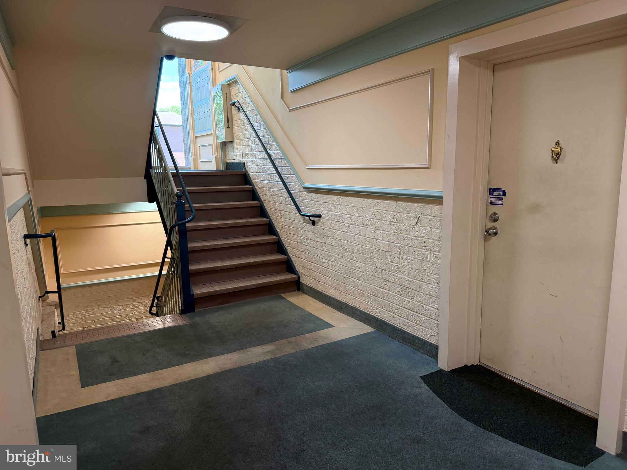 8007 Mandan Road, Unit 605 Greenbelt, MD 20770 - Photo 15 of 15 a view of a hallway with staircase
