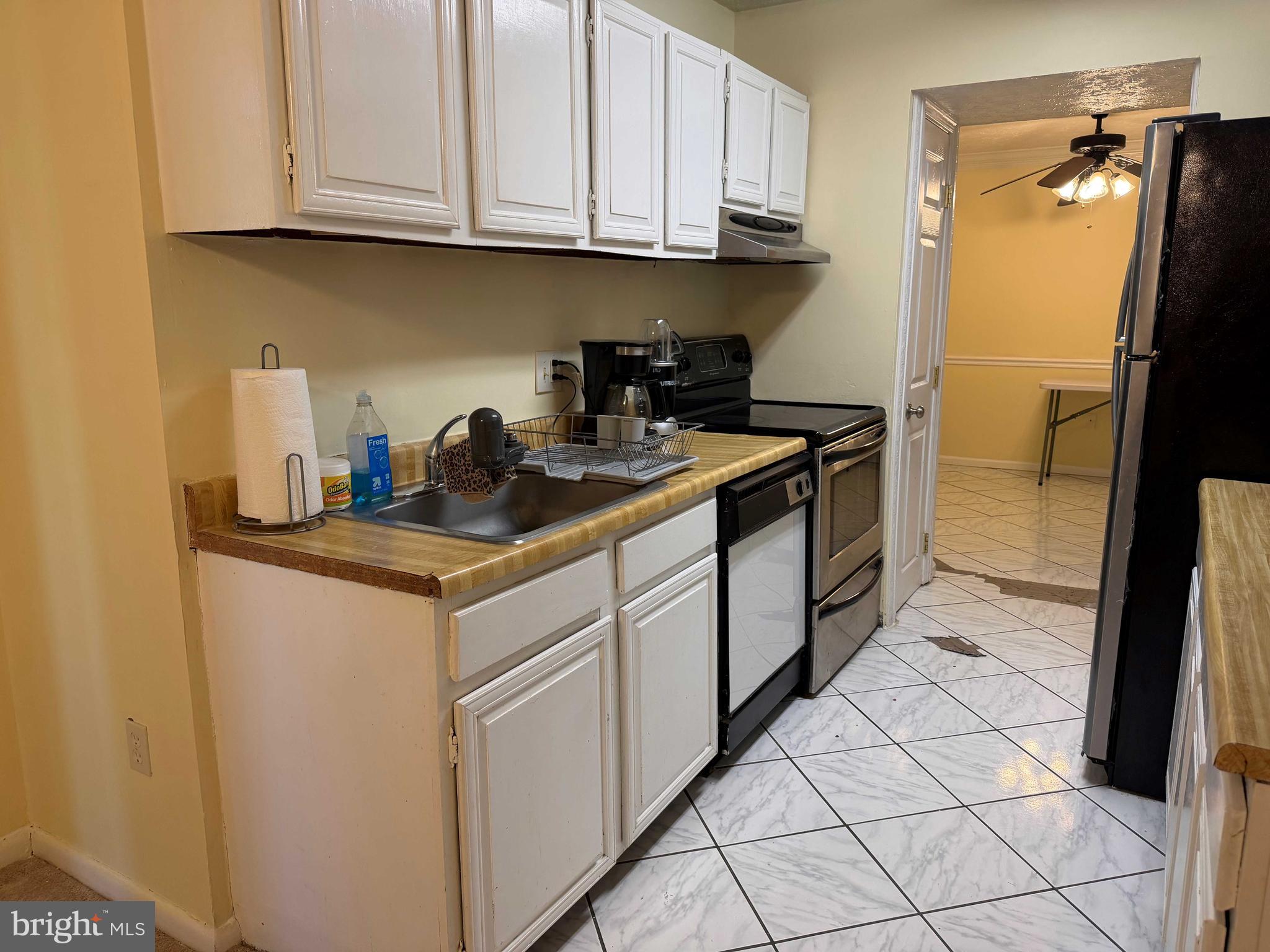 8007 Mandan Road, Unit 605 Greenbelt, MD 20770 - Photo 2 of 15 a kitchen with stainless steel appliances granite countertop a stove a refrigerator and cabinets
