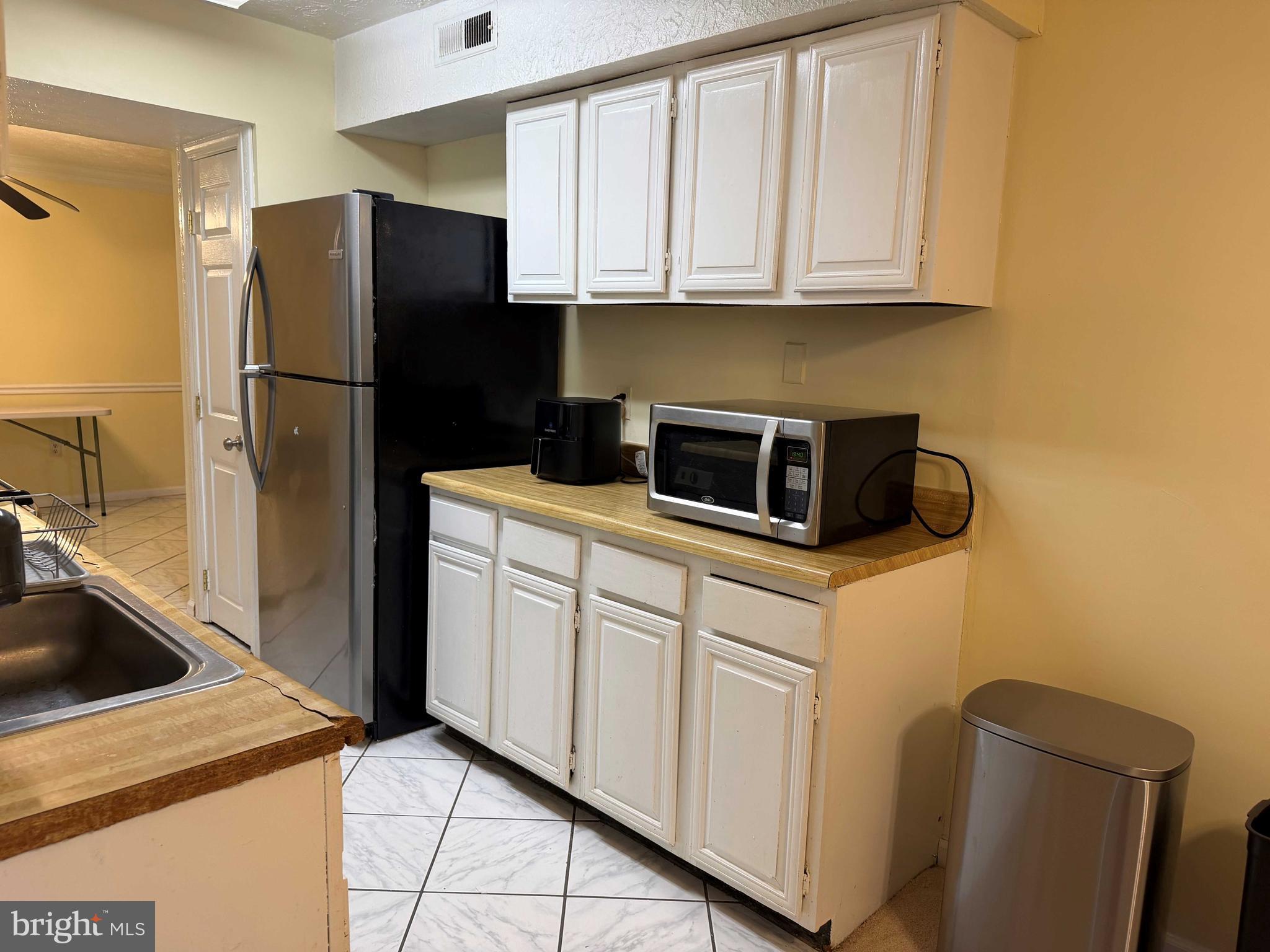 8007 Mandan Road, Unit 605 Greenbelt, MD 20770 - Photo 3 of 15 a kitchen with stainless steel appliances granite countertop a refrigerator a stove a sink and dishwasher