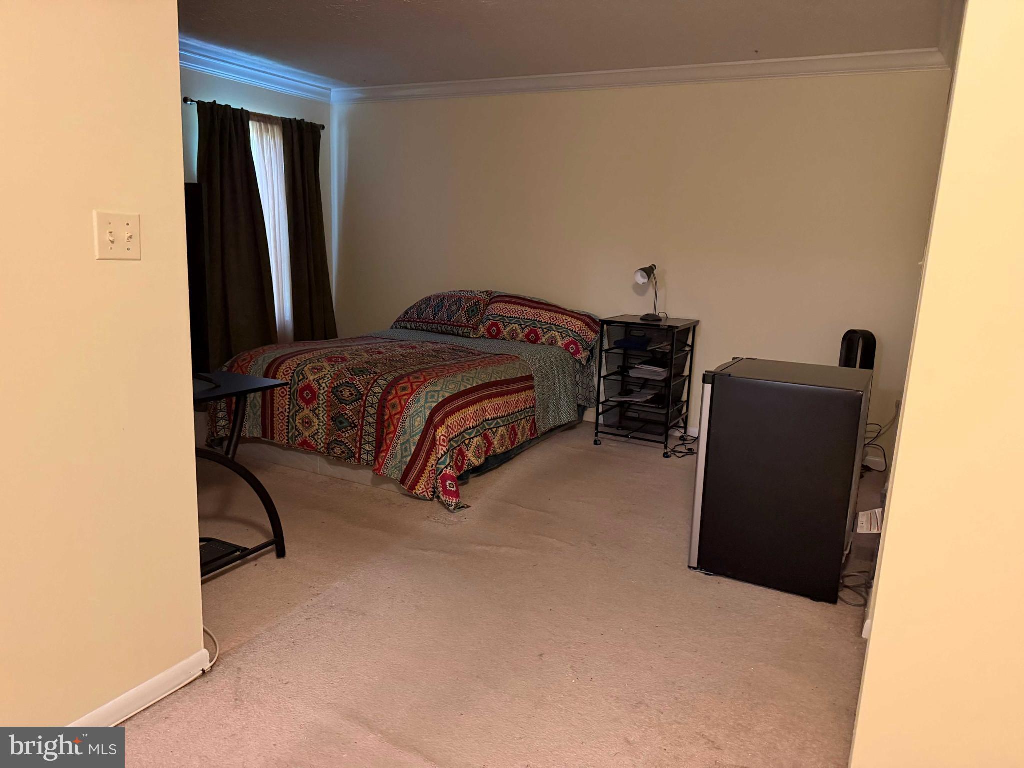 8007 Mandan Road, Unit 605 Greenbelt, MD 20770 - Photo 5 of 15 a bedroom with a bed and wooden floor