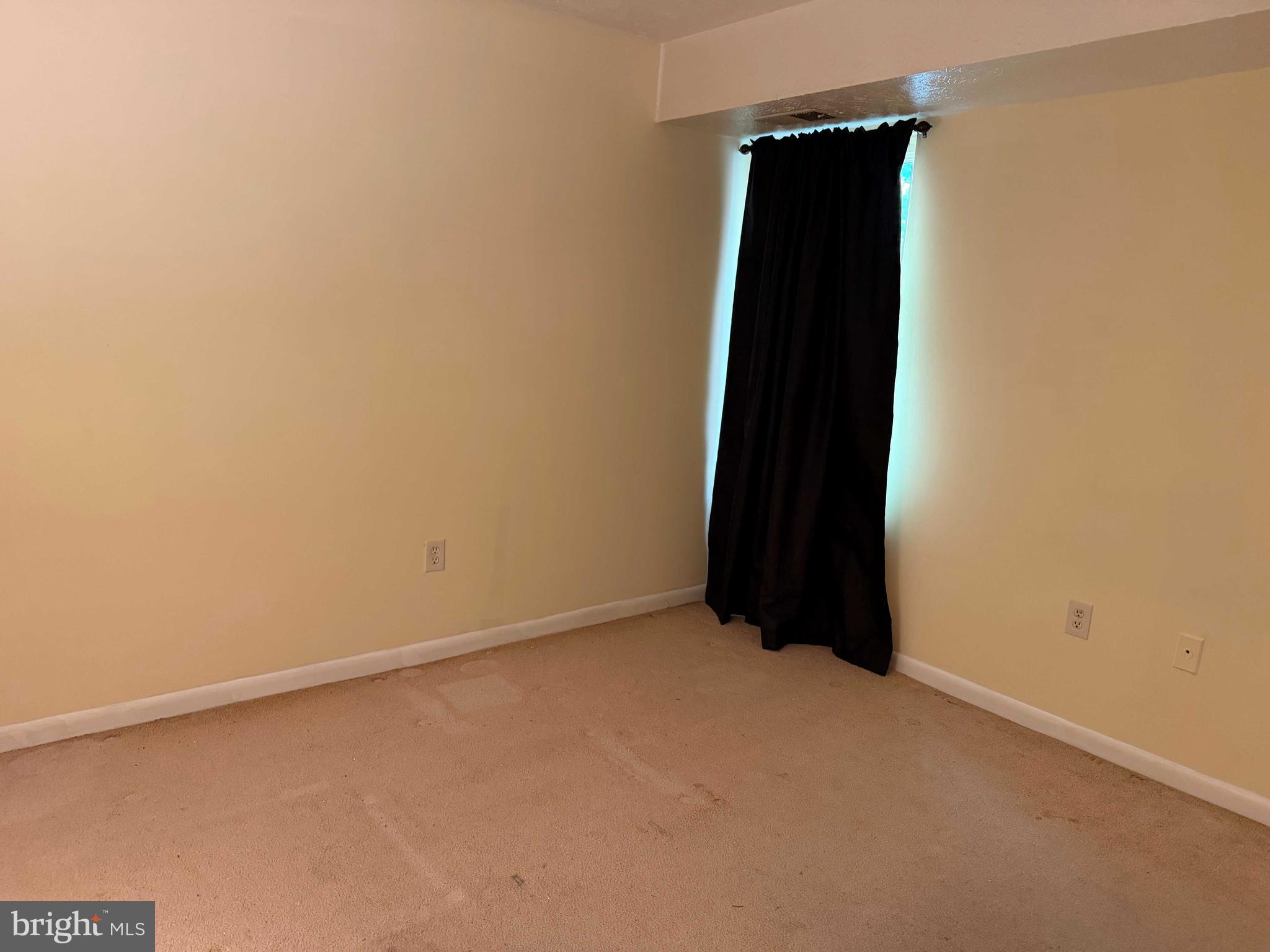 8007 Mandan Road, Unit 605 Greenbelt, MD 20770 - Photo 8 of 15 an empty room with a black gate