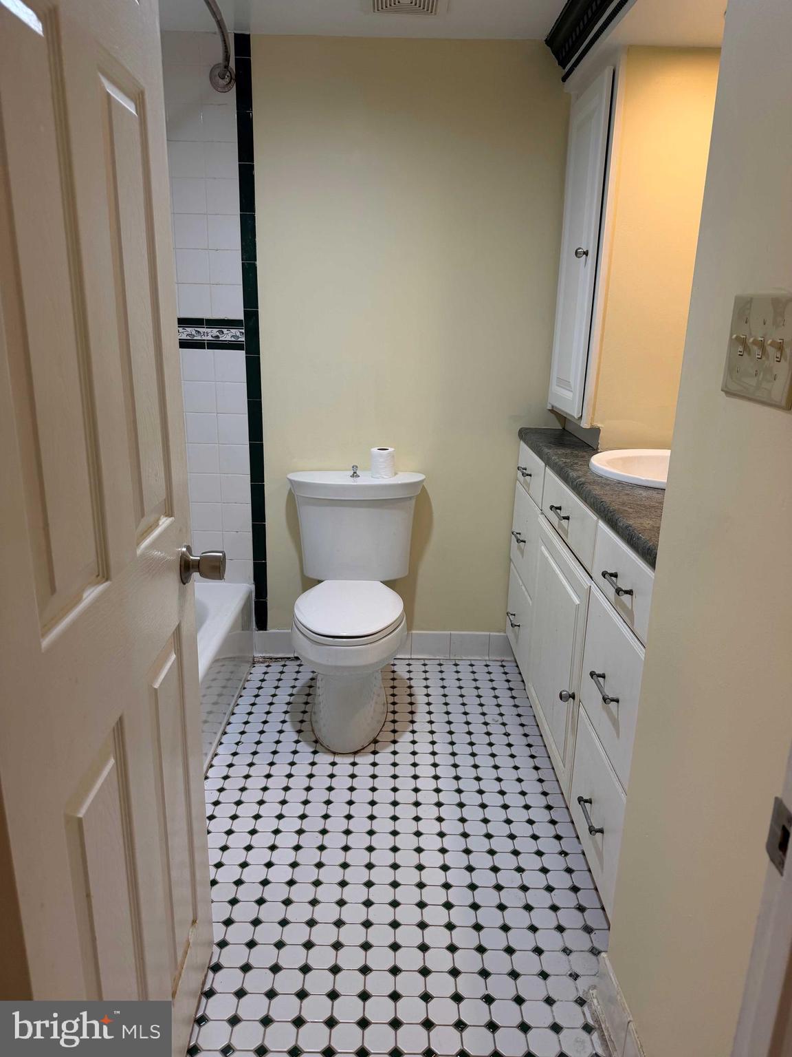 8007 Mandan Road, Unit 605 Greenbelt, MD 20770 - Photo 10 of 15 a bathroom with a toilet a sink and a mirror