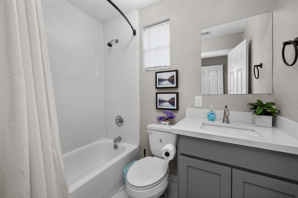 2504 Ferguson Way Houston, TX 77088 - Photo 15 of 32 a bathroom with a sink a toilet a mirror a vanity and shower