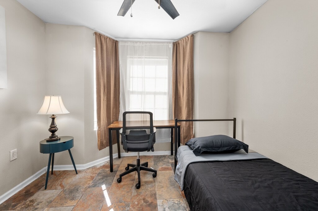 2504 Ferguson Way Houston, TX 77088 - Photo 20 of 32 a bedroom with a bed and a lamp on table