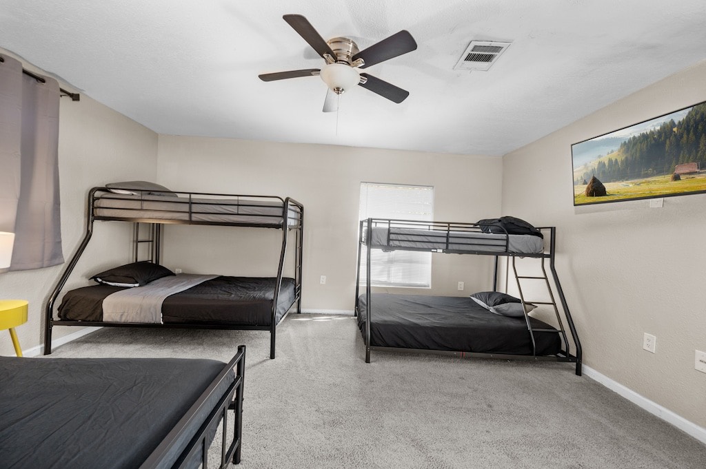 2504 Ferguson Way Houston, TX 77088 - Photo 21 of 32 a bedroom with a bed and a chandelier