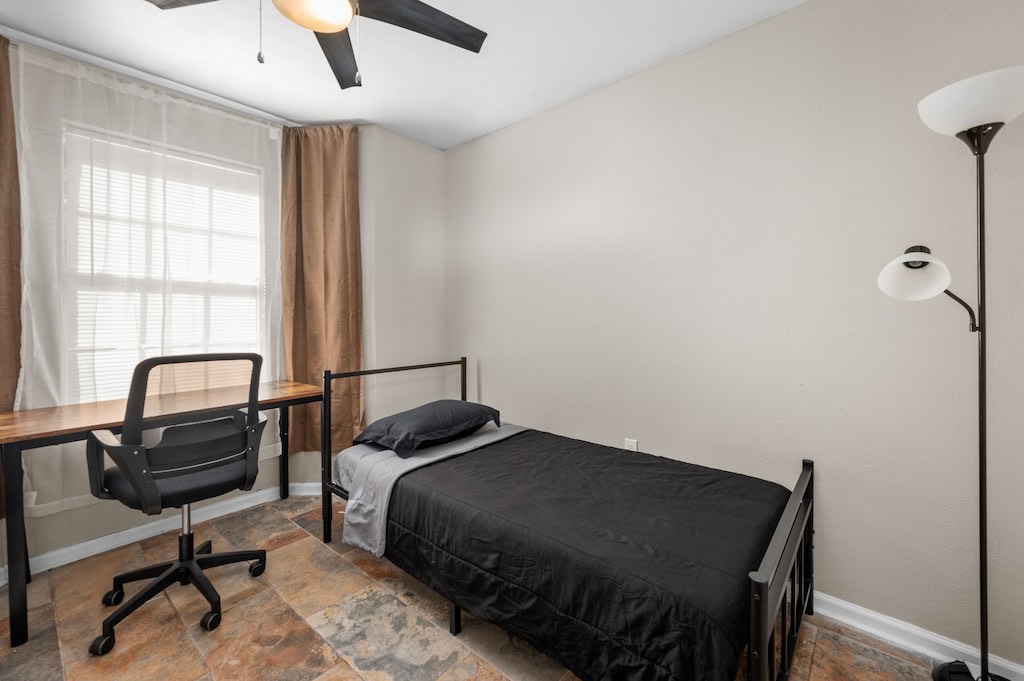 2504 Ferguson Way Houston, TX 77088 - Photo 24 of 32 a bedroom with a bed and a desk
