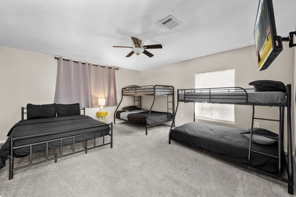 2504 Ferguson Way Houston, TX 77088 - Photo 26 of 32 a bedroom with furniture and a chandelier