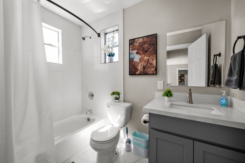 2504 Ferguson Way Houston, TX 77088 - Photo 27 of 32 a bathroom with a granite countertop sink toilet and a bathtub