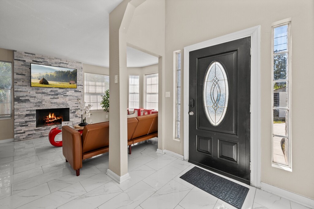 2504 Ferguson Way Houston, TX 77088 - Photo 3 of 32 a living room with furniture a mirror and a fireplace