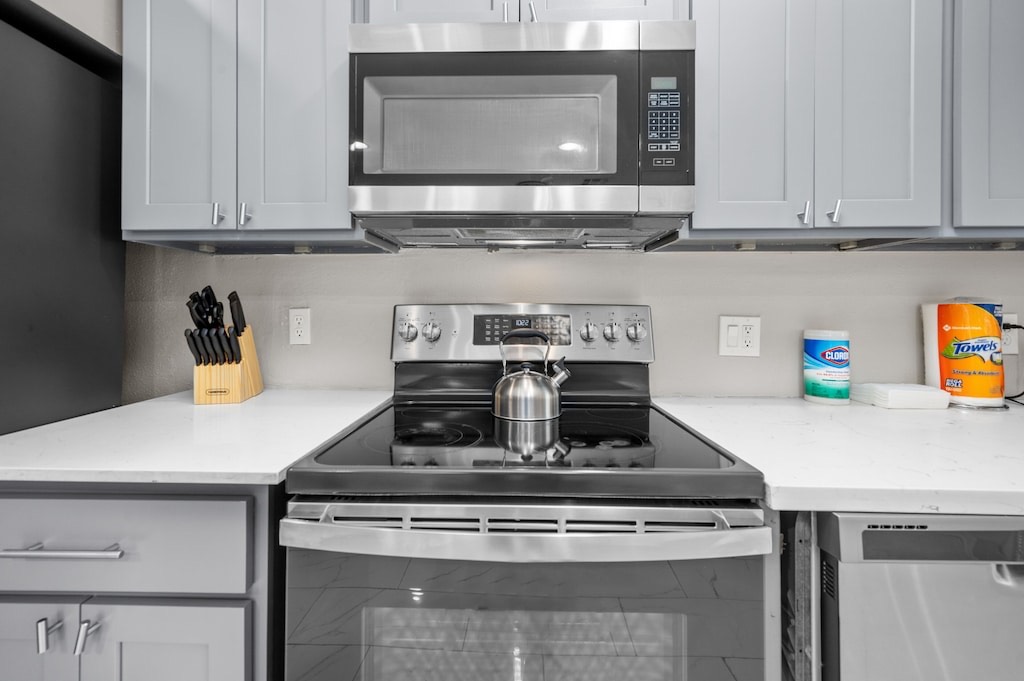 2504 Ferguson Way Houston, TX 77088 - Photo 7 of 32 a stove top oven sitting inside of a kitchen and white cabinets