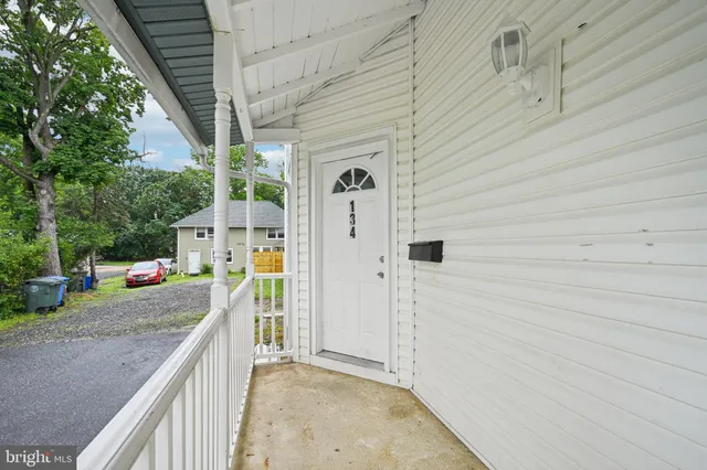 an empty room with wooden floor and a window