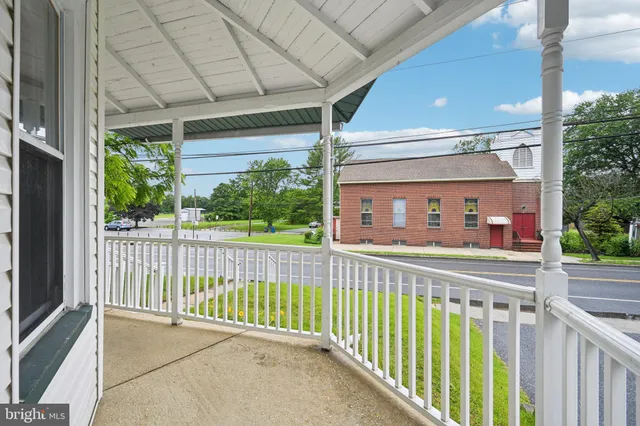 a large kitchen with stainless steel appliances granite countertop a refrigerator and a sink