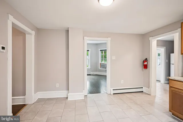 an empty room with window and wooden floor