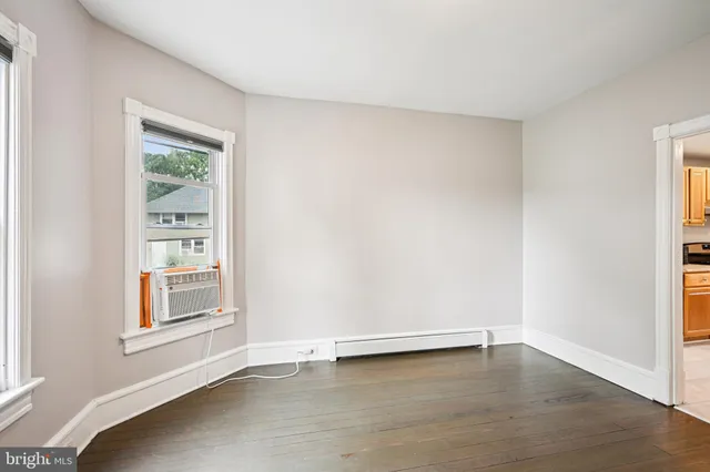 a view of an empty room with wooden floor