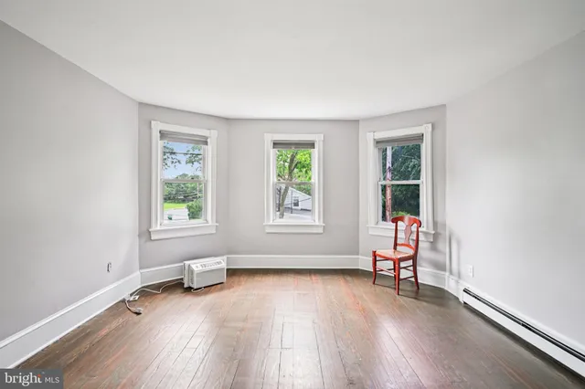 a view of a house with a yard and sitting area