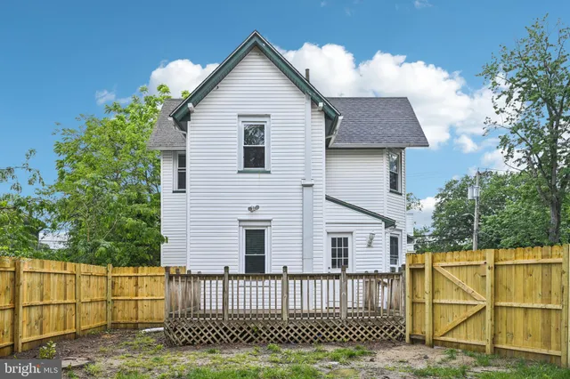 an aerial view of a house with a garden and a car parked