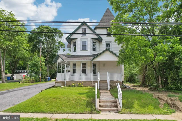 an aerial view of a house with garden space and street view
