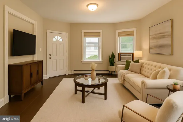 a living room with furniture and a flat screen tv