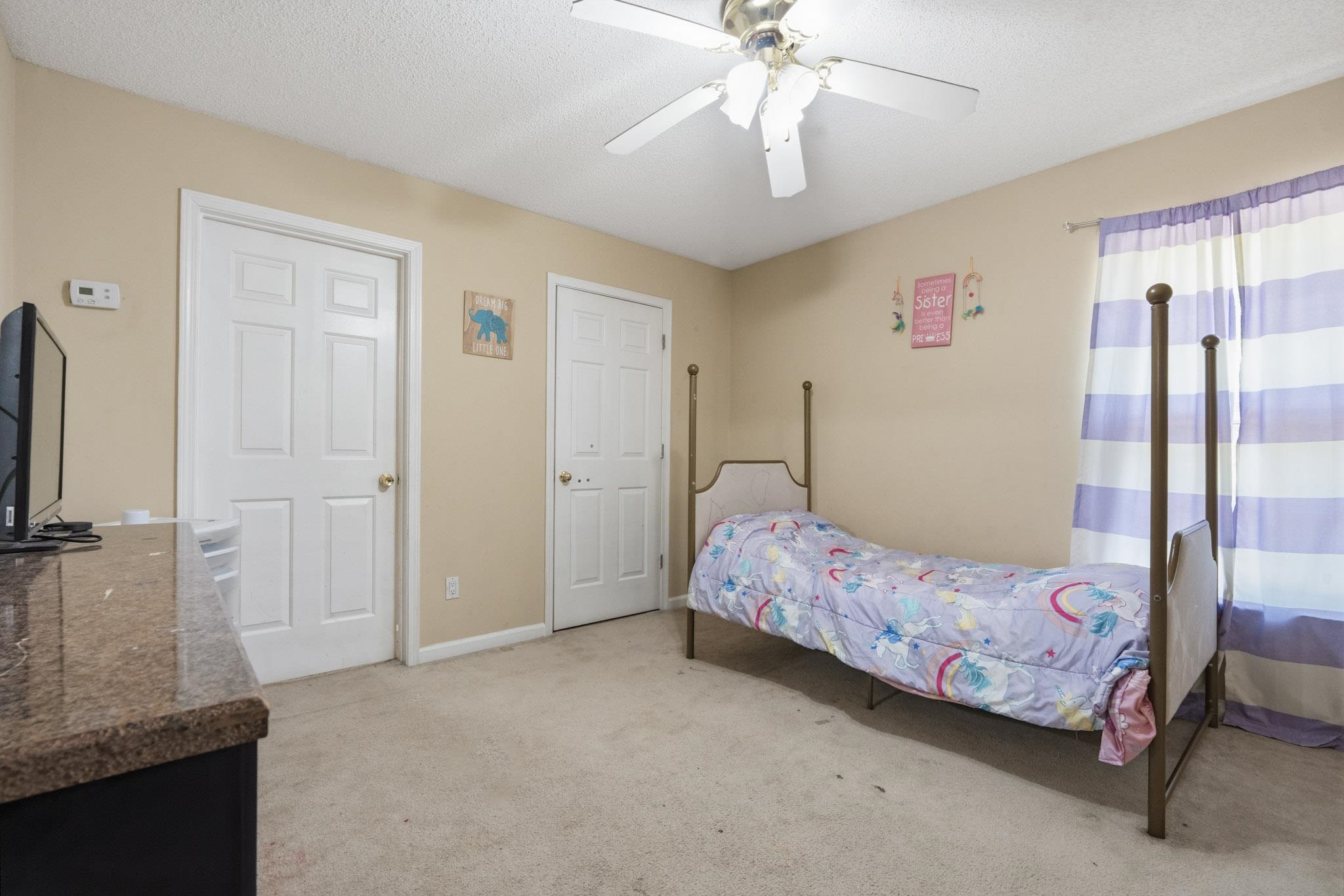 7105 Cutter Mill Road Memphis, TN 38141 - Photo 19 of 23 Bedroom featuring light carpet, a textured ceiling, and a ceiling fan