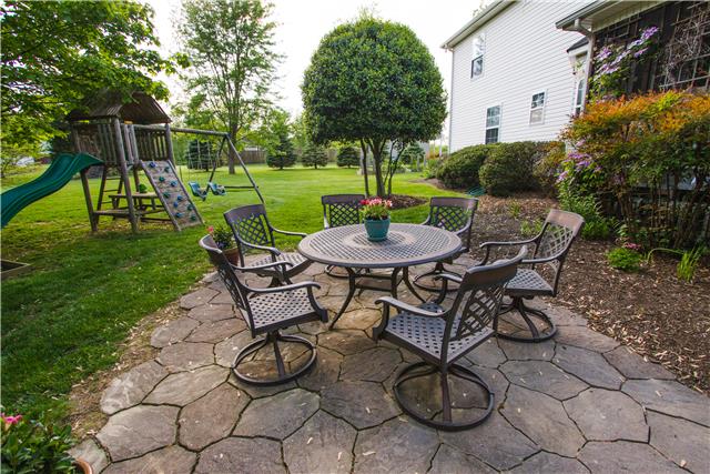 4155 Bethlehem Road Springfield, TN 37172 - Photo 17 of 19 This backyard was meant for entertaining. A beautiful stone patio and a swing set for the little ones to enjoy. There is a HUGE, lush green lawn with numerous mature trees that give you the perfect amount of shade.