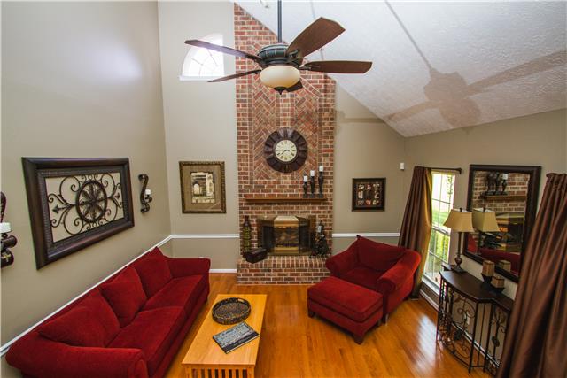 4155 Bethlehem Road Springfield, TN 37172 - Photo 4 of 19 Walk through the front door into the brilliant living room that comes to life with all the natural sunlight. Real wood floors and a floor-to-ceiling brick fireplace. Perfect for entertaining! The first of 2 staircases leading to the second story.