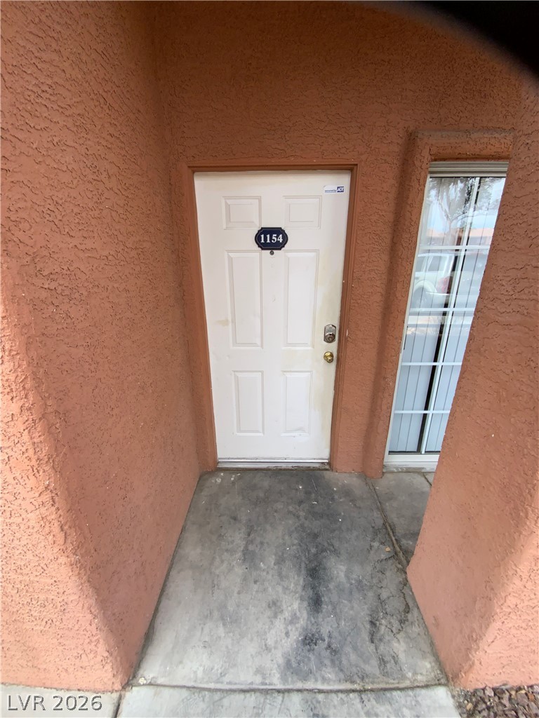 4730 East Craig Road, Unit 1154 Las Vegas, NV 89115 - Photo 5 of 13 Secure entry point with textured stucco and a practical window nearby.