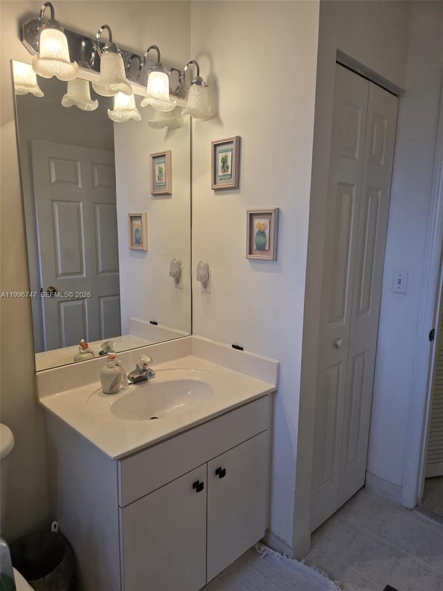 13016 Southwest 142nd Terrace Miami, FL 33186 - Photo 19 of 67 a bathroom with a sink and a mirror