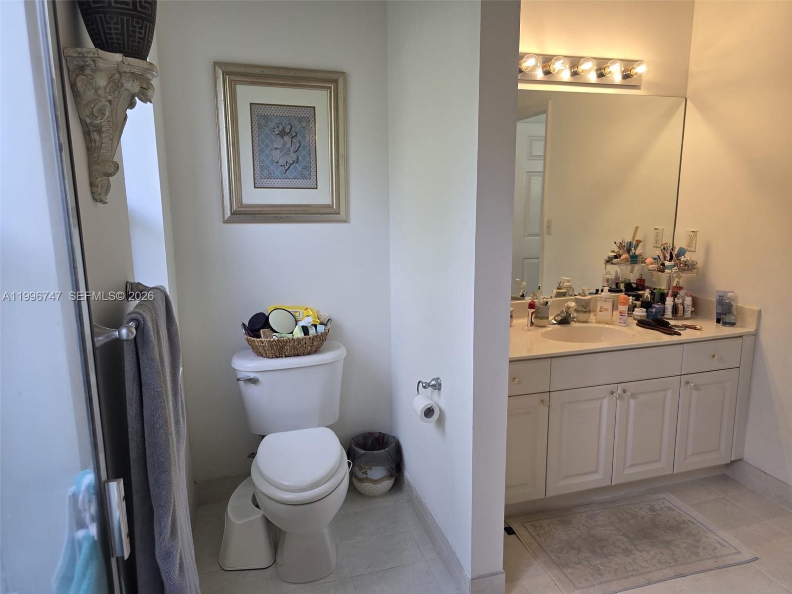 13016 Southwest 142nd Terrace Miami, FL 33186 - Photo 20 of 67 a bathroom with a toilet a sink and mirror